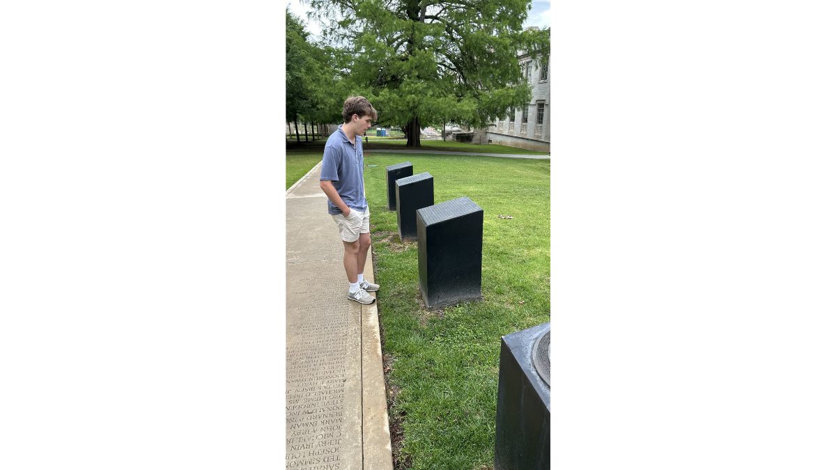 Carter reading the Silas Hunt memorial stones
