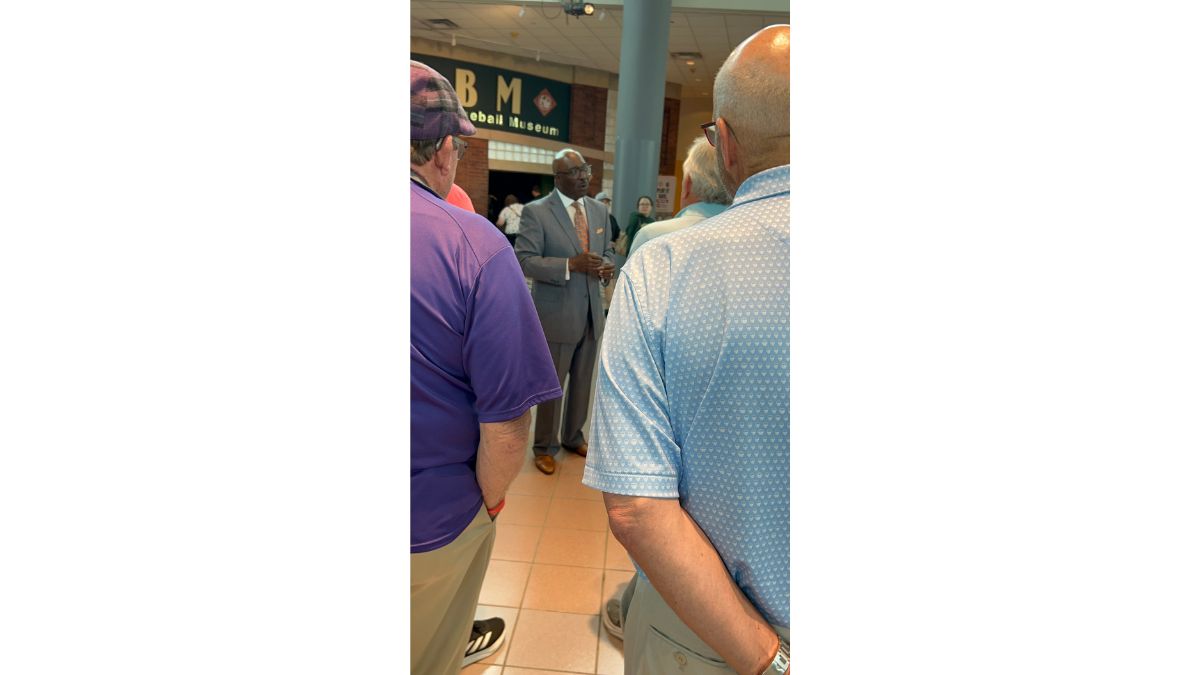 Museum director addresses visitors in the lobby