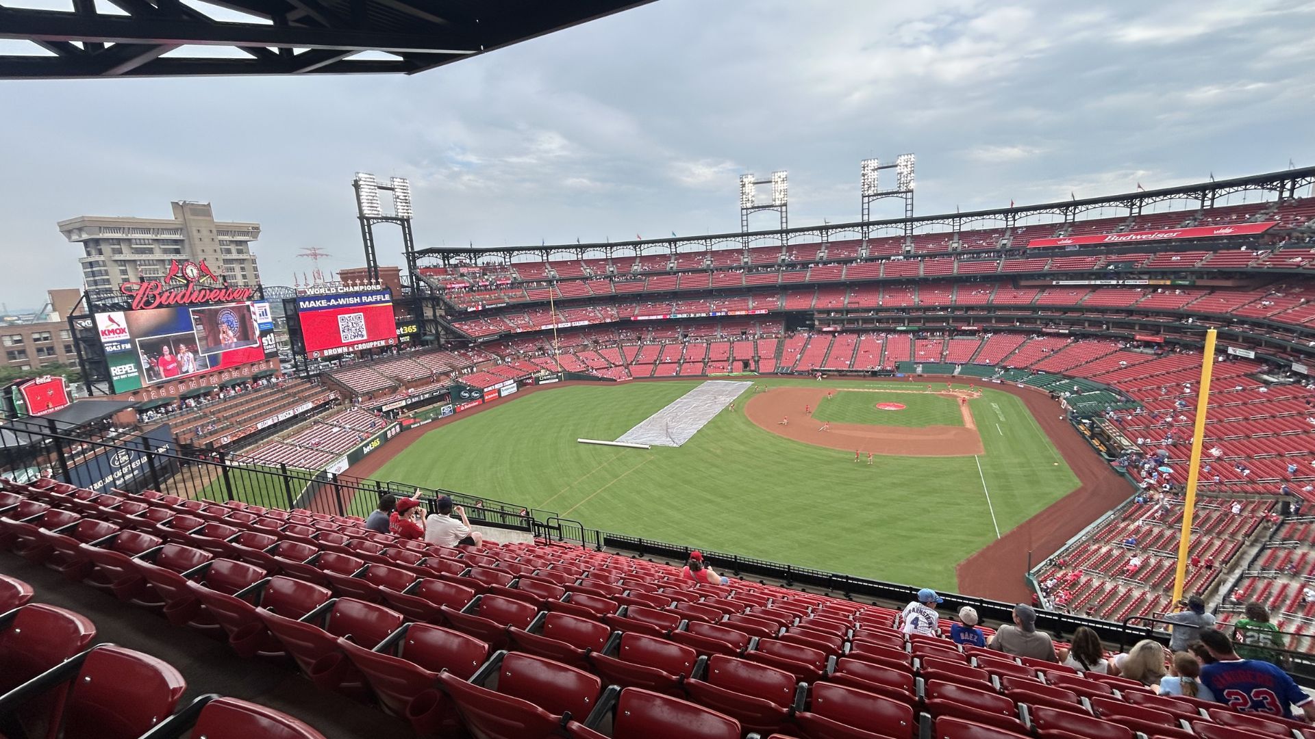 Tarp coming off after rain delay at Busch Stadium